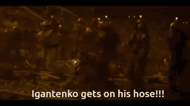 a man in a helmet stands in front of a crowd and says igantenko gets on his hose !!