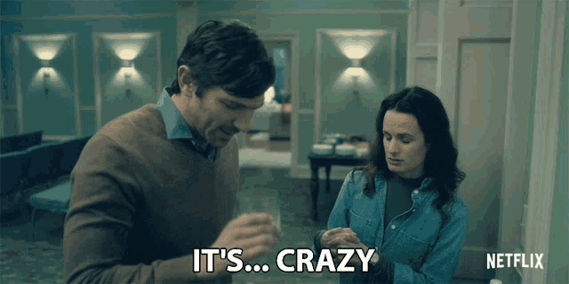 a man and a woman are standing next to each other and the man is saying it 's crazy