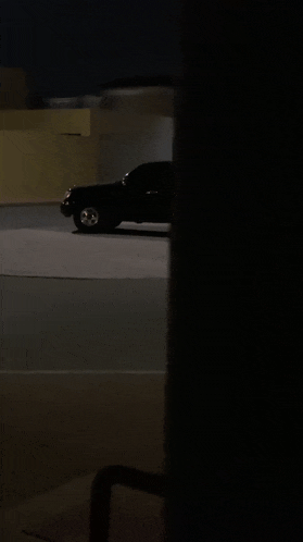 a black suv is parked in a parking lot