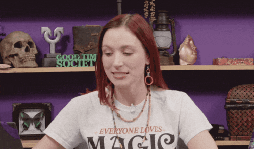 a woman is wearing a white shirt that says everyone loves magic