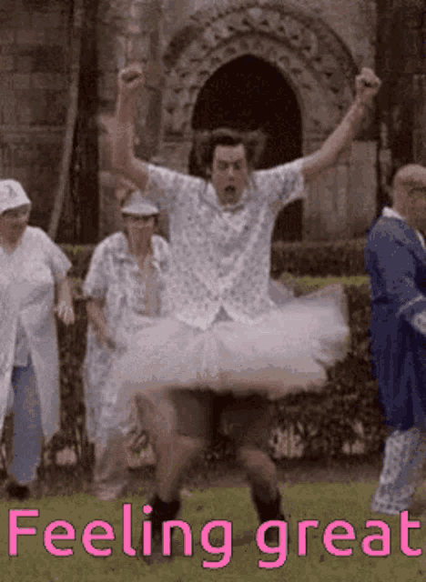 a man in a tutu is jumping in the air in front of a group of people with the caption feeling great