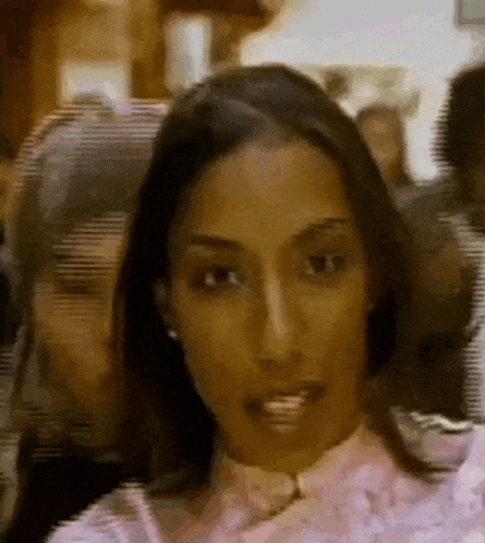 a blurry picture of a woman in a pink shirt and bow tie