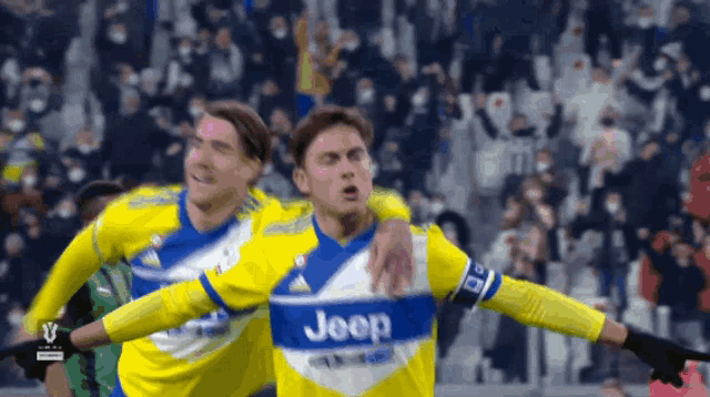 two soccer players wearing yellow and blue jerseys with the word jeep on them