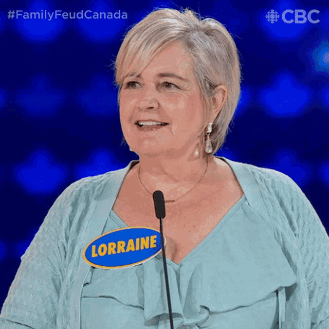 a woman wearing a name tag that says lorraine on it