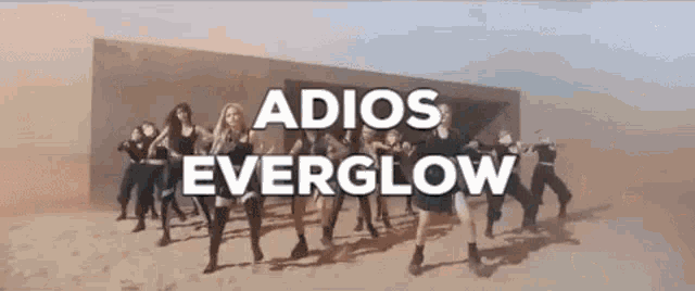 a group of women are dancing in front of a building with the words `` adios everglow '' written on it .