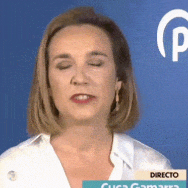 a woman with her eyes closed is wearing a white shirt that says directo