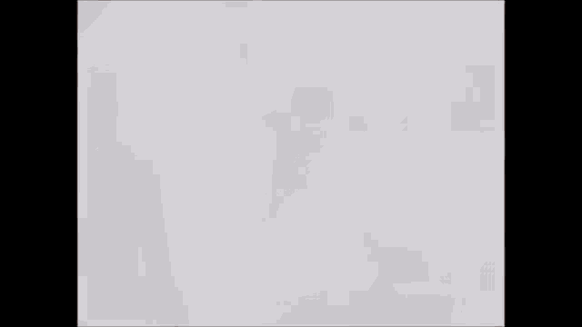 a blurry picture of a person smoking a cigarette .