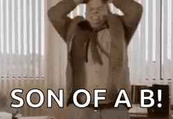 a man in a suit and tie is holding his head and saying son of a b !
