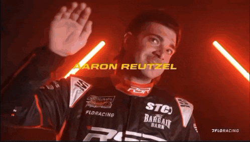 a close up of a person 's hand with the name aaron reutzel on the bottom right