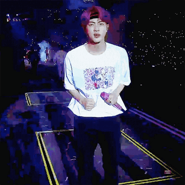 a man wearing a white t-shirt with a picture of a group of people on it