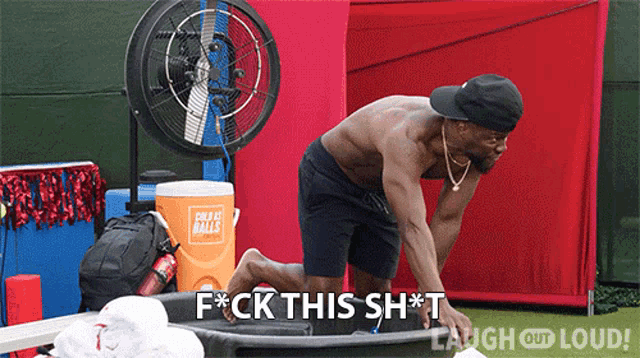 a shirtless man is standing in front of an orange cooler that says " great balls " on it