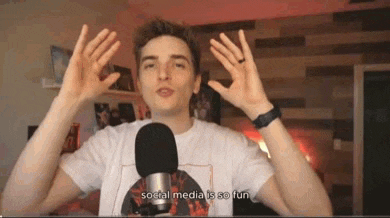 a young man is standing in front of a microphone .