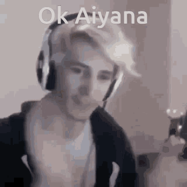 a man wearing headphones says ok aiyana in a blurry picture