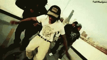 a group of young men are dancing in front of a city skyline and a sign that says ' tails '