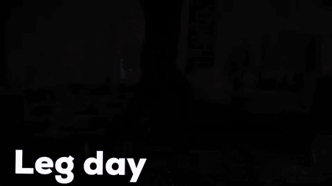 a woman is doing leg day exercises in a living room with a couch .