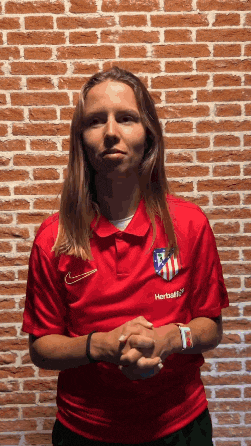 a woman wearing a red shirt with herbalife written on it