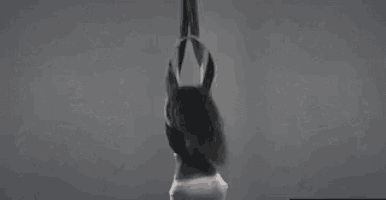a close up of a person 's hand reaching out towards a black object .
