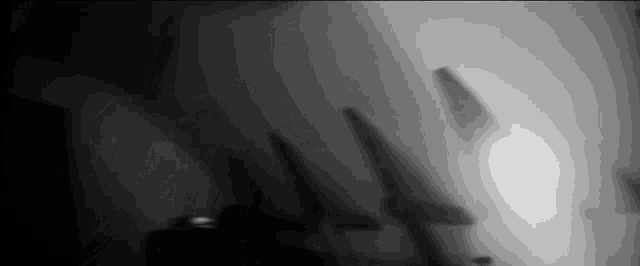 a black and white photo of a shadow on a wall
