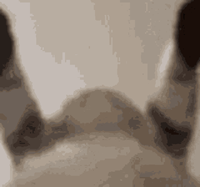 a close up of a person 's feet standing next to each other on a table .