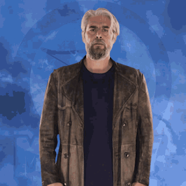 a man with a beard wearing a brown jacket