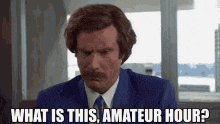 a man in a suit and tie says what is this amateur hour .