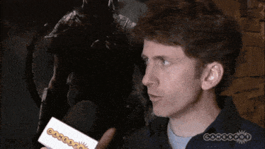 a man is holding a card that says gamespot on it