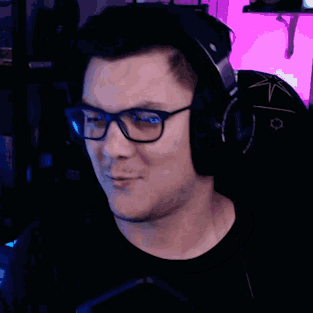 a man wearing glasses and headphones looks at something