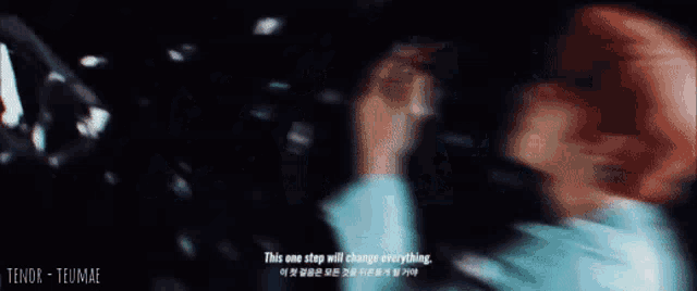 a person standing in a dark room with their arms outstretched and bubbles falling around them