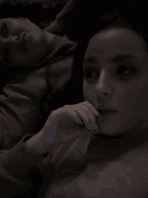 a person covering a woman 's face with their hands