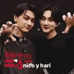 a man is pointing at another man in a blurry photo and says nico y hari .