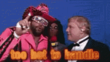 a man in a pink suit says too hot to handle while another man in a suit looks on