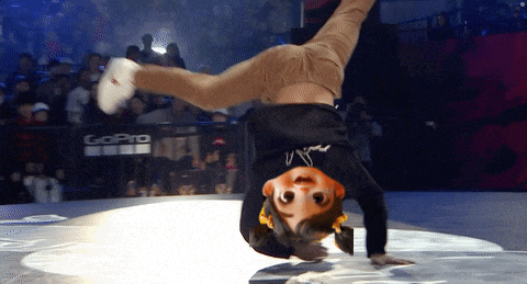 a person is doing a handstand in front of a gopro banner
