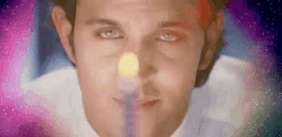 a close up of a man 's face with a candle in his nose .