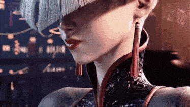 a close up of a woman 's face wearing a fringed hat and earrings .