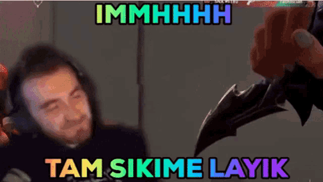 a man wearing headphones is holding a knife with the words immhhhh tam sikime layik written above him