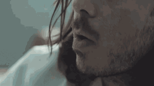 a close up of a man 's face with his mouth open