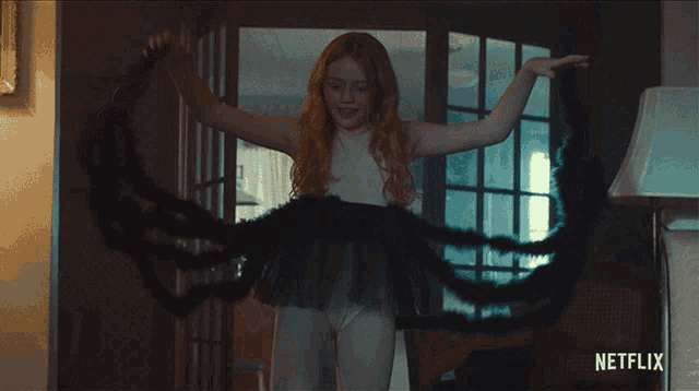 a girl is dancing in a room with a netflix logo on the bottom right