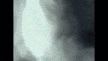 a close up of a person 's face in a dark room .