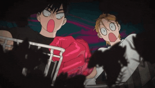 a man and a woman are making funny faces in a dark room