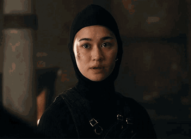 a woman in a black hood says i loved her too in white letters