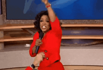 a woman in a red dress is holding a microphone in her hand .