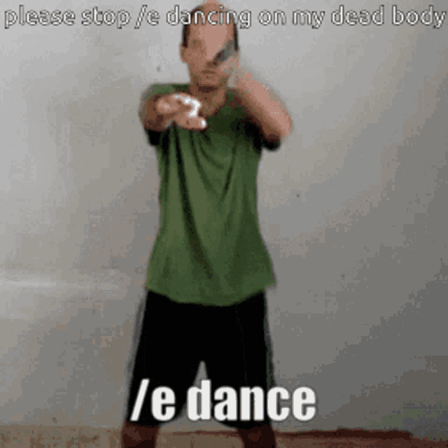 a man in a green shirt and black shorts is dancing on his dead body while holding a wii controller