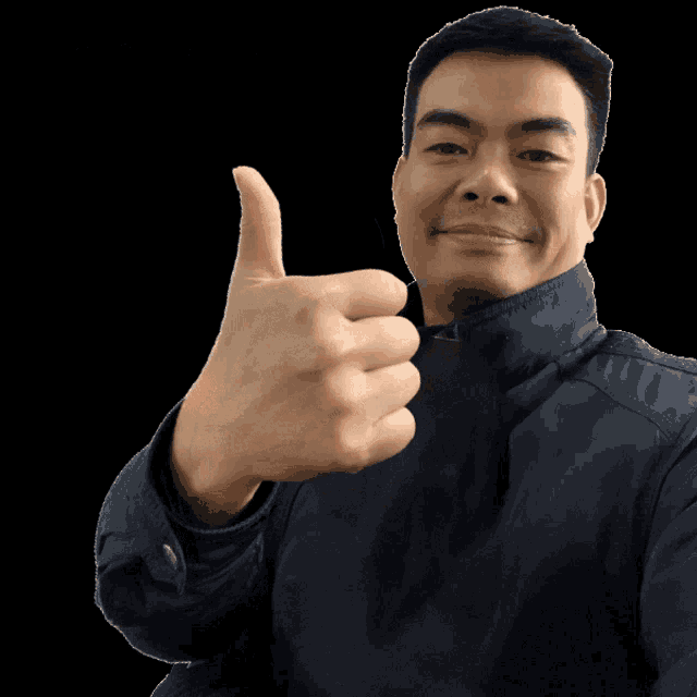 a man is giving a thumbs up in front of a sign that says ok