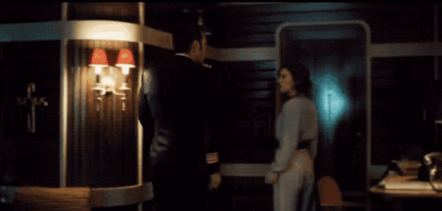 a man and woman are standing next to each other in a room