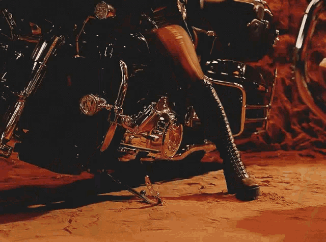 a woman is sitting on a motorcycle holding the handlebars
