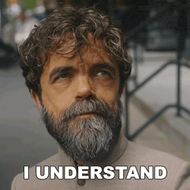 a man with a beard says " i understand " in front of his face