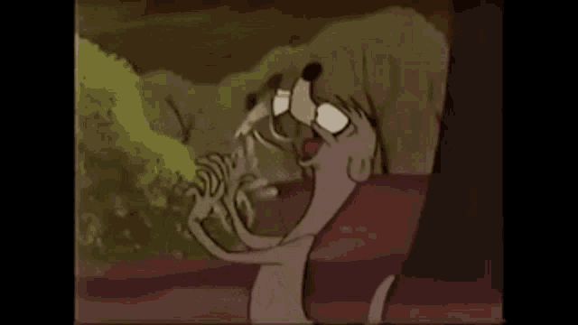a cartoon squirrel is standing next to a tree in the woods .