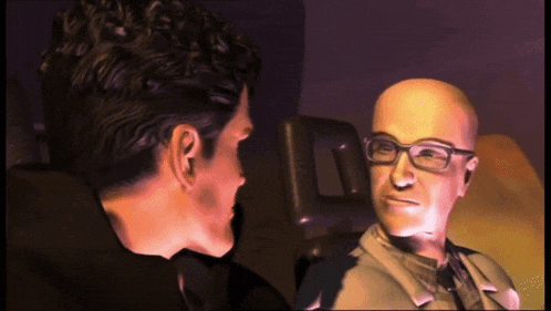 a bald man wearing glasses is talking to another bald man