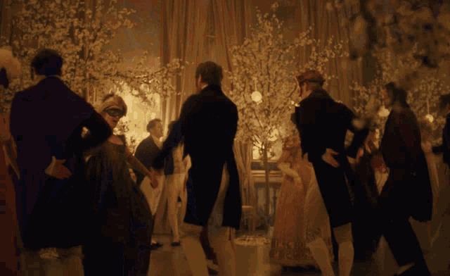 a group of people are dancing in a room