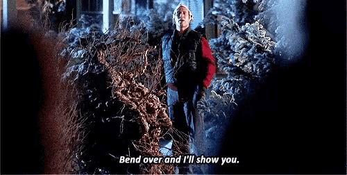 a man is standing in front of a pile of branches with the words bend over and i 'll show you .